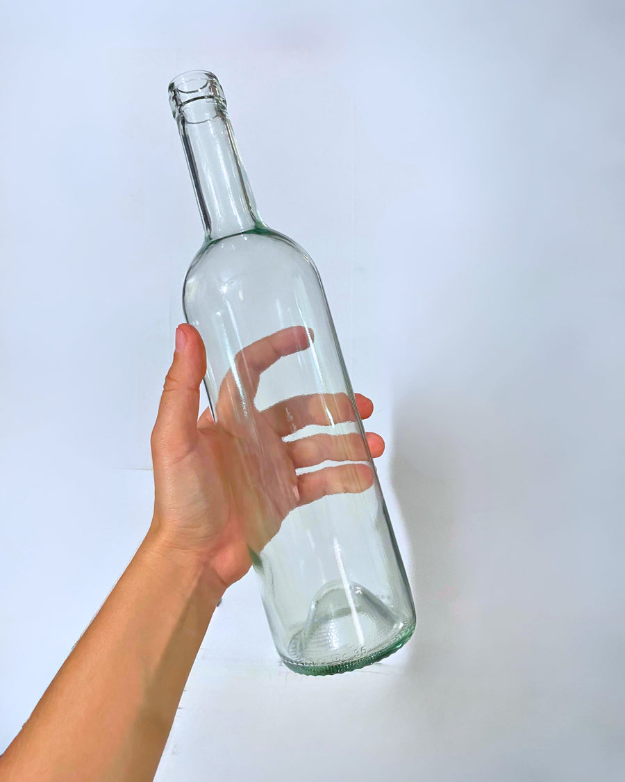 Botella de vidrio transparente tipo Burdeos de 750 ml, ideal para presentación de vino blanco artesanal o industrial.